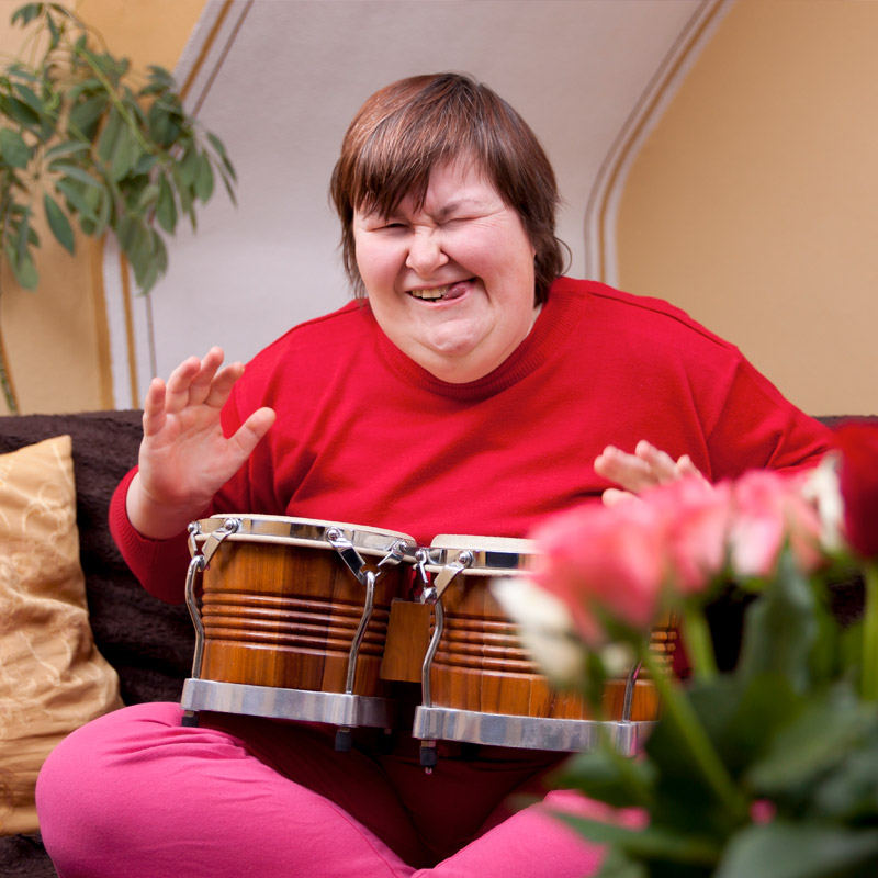 adults with down syndrome playing drum