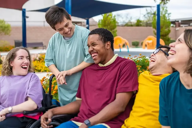 Group of friends smiling and laughing together outside