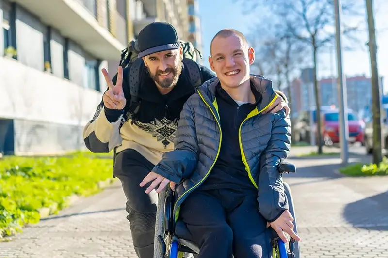 Disabled man and friend walking outside